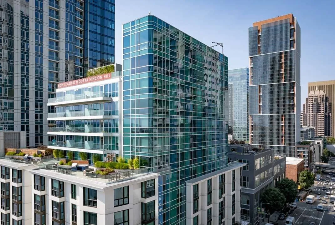 Exterior image of building showing private balconies overlooking community terrace