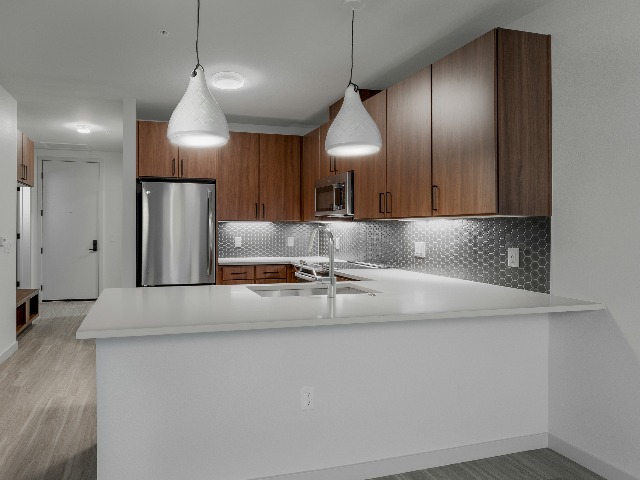 White kitchen island shown in warm wood-toned kitchen