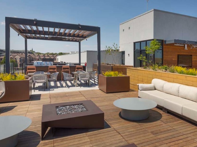 Outdoor dining area and BBQ grilling stations with panoramic city views