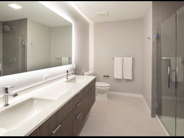 Bathroom at Modera LoHi showing gray and white color scheme and flooring