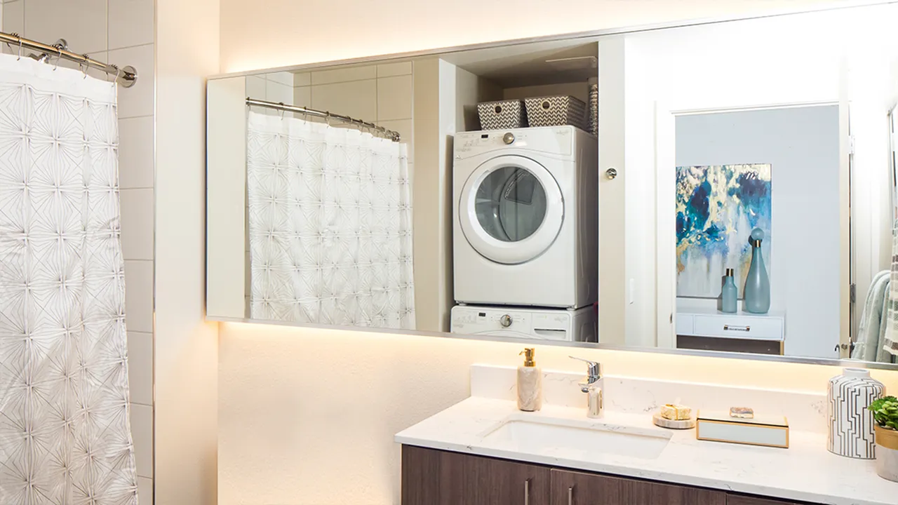 Bathroom with extended, back lit vanity mirror