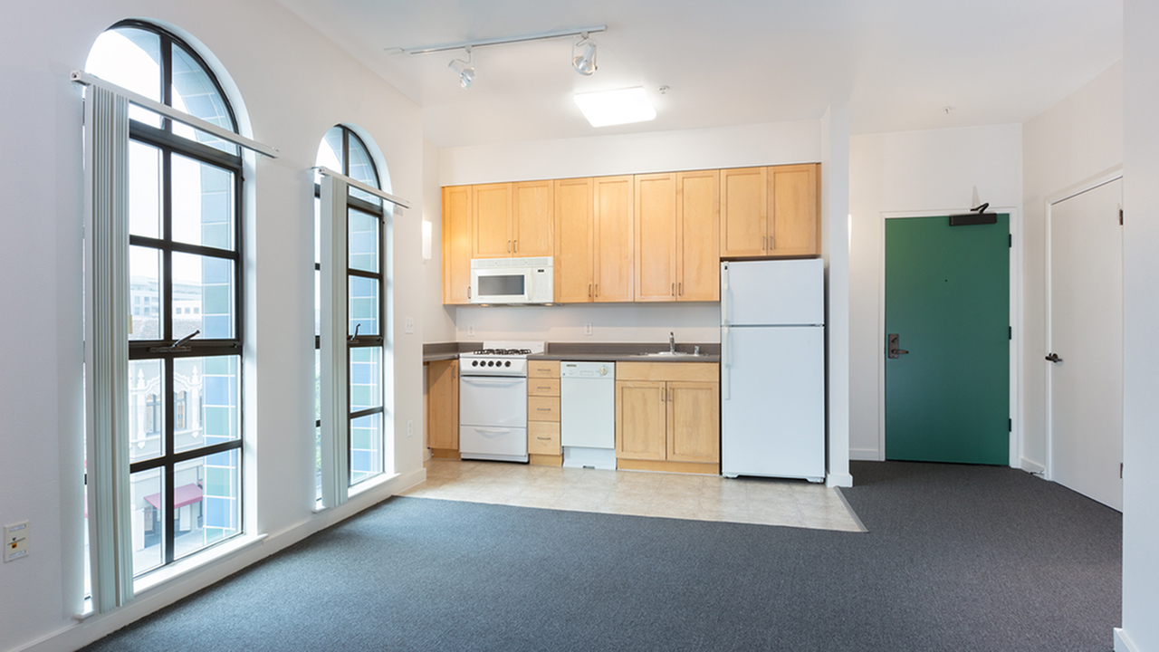 Open Concept Living Room and Kitchen with decorative floor to ceiling windows