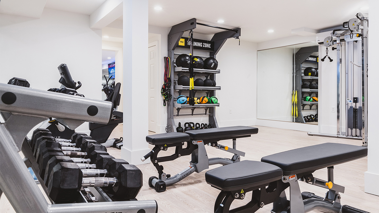 fitness center with stretch area, benches and free weights