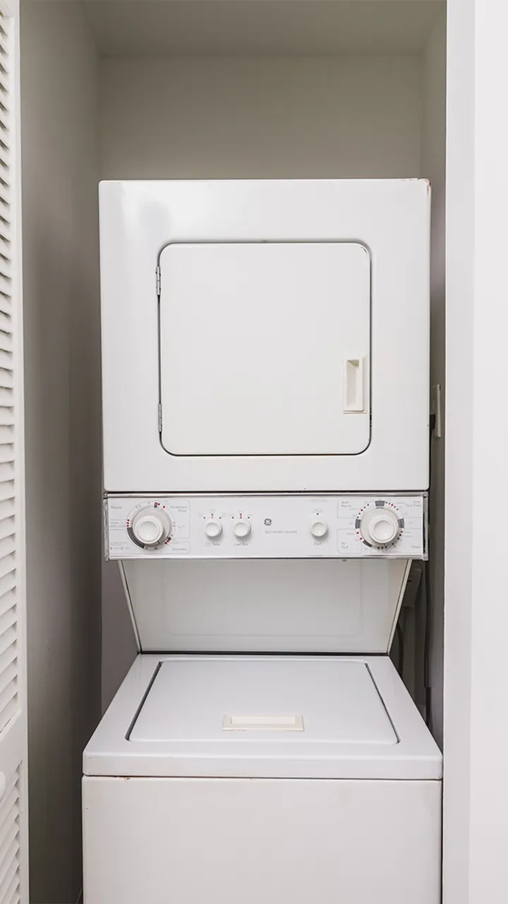 Stackable washer and dryer in closet.