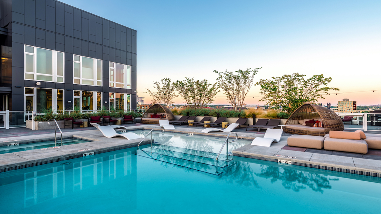 Pool with resort-inspired lounge seating and private cabanas