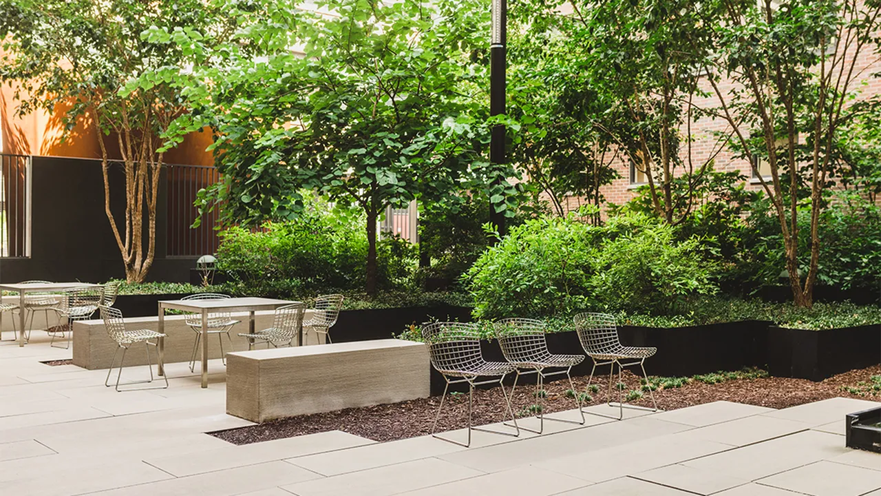 Landscaped outdoor patio with seating and tables
