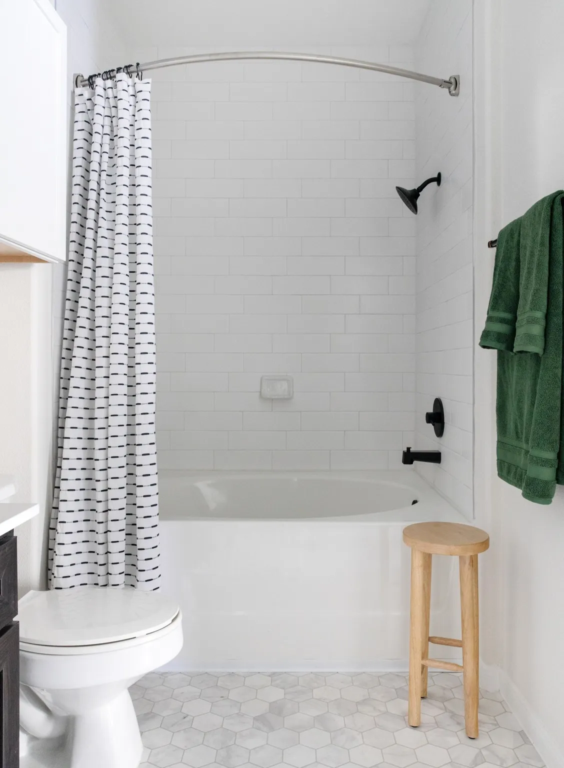 soaking tub with tile finishes in bathroom