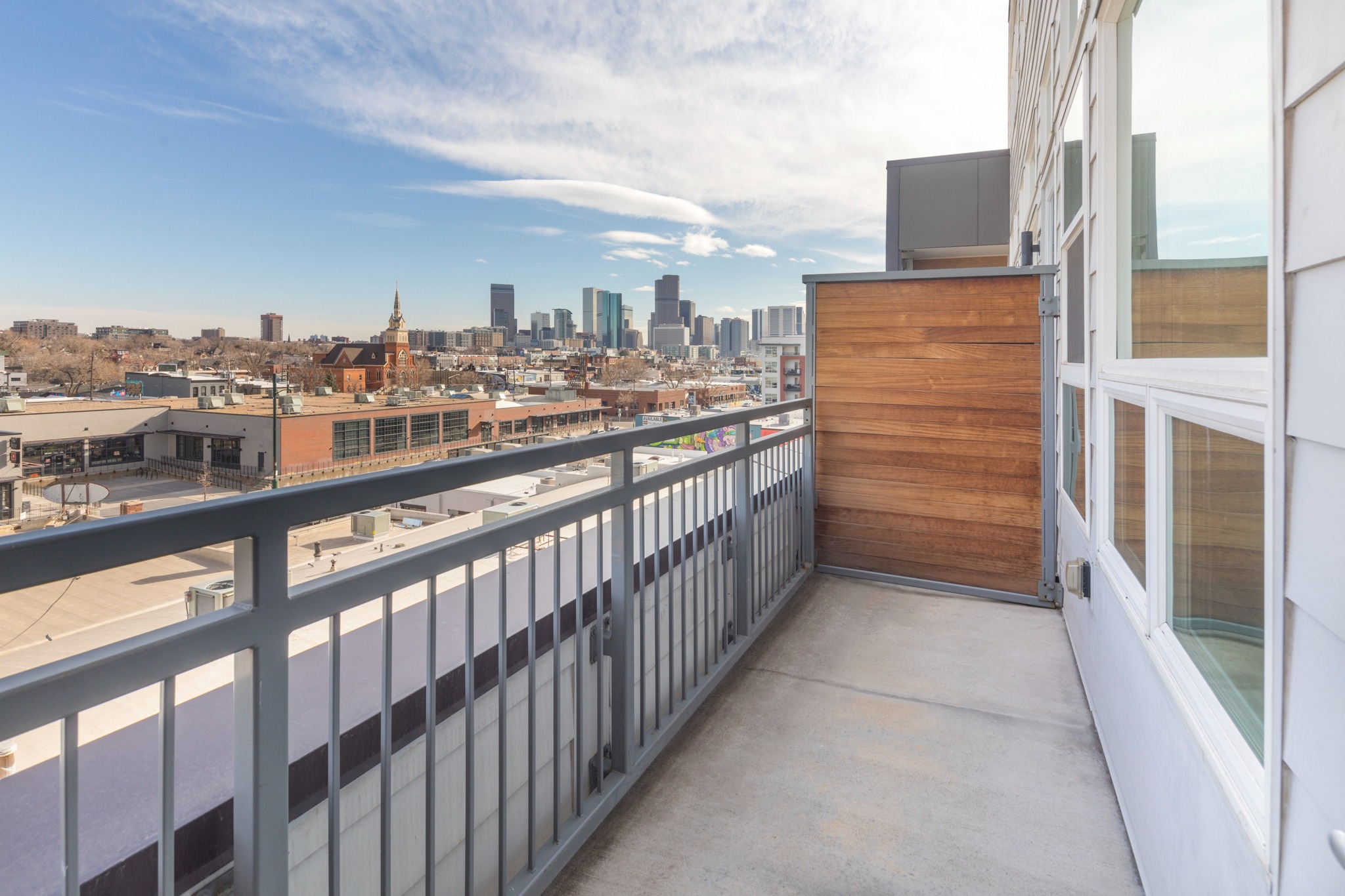 city views on private balcony at modera river north apartment homes for rent in denver colorado