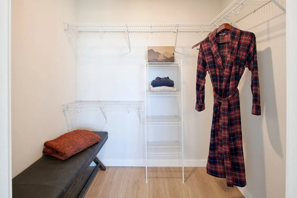 Built-in storage shelves in bathroom next to shower
