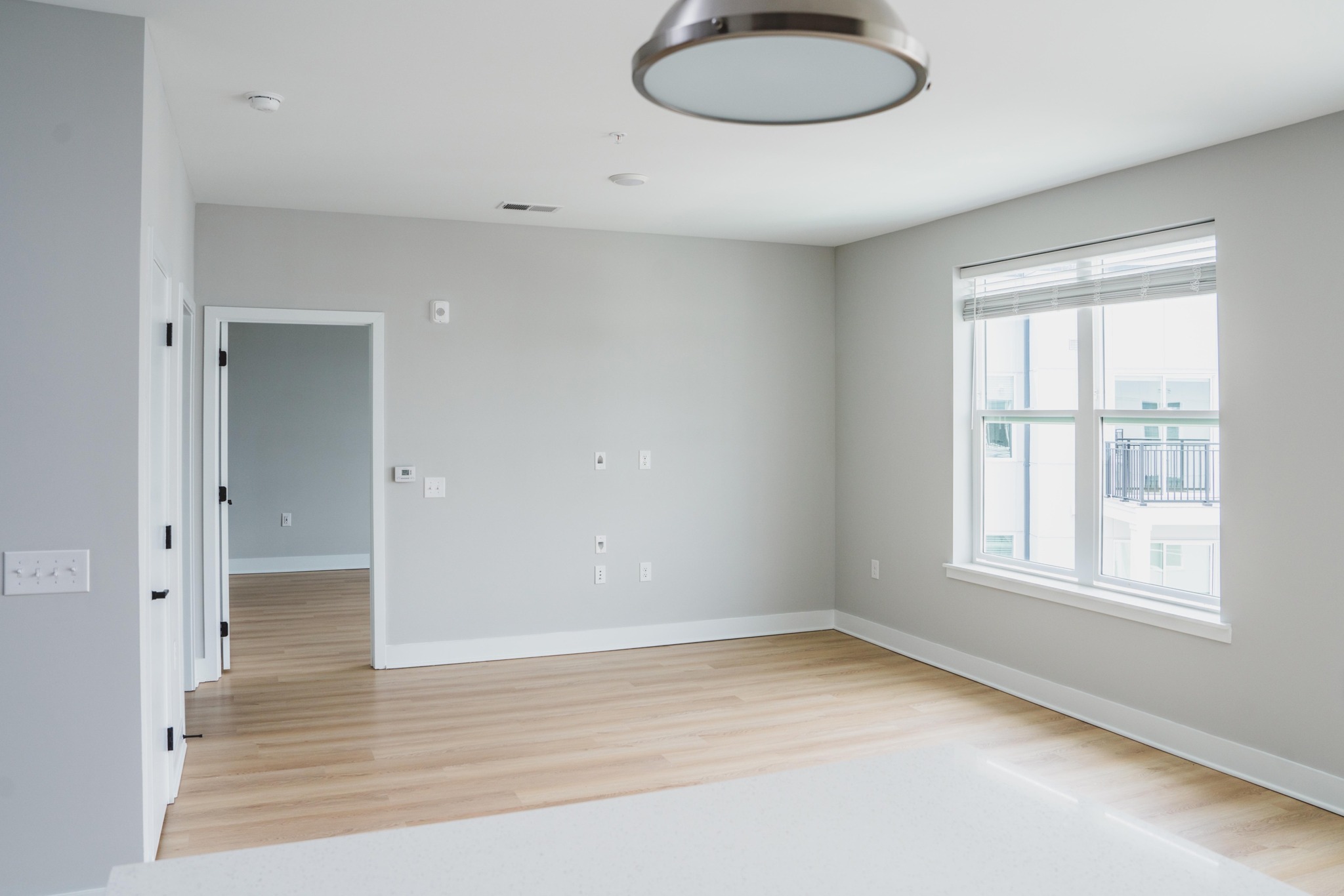 wood plank style flooring and large windows with natural light at modera germantown apartment homes for rent in nashville tennessee