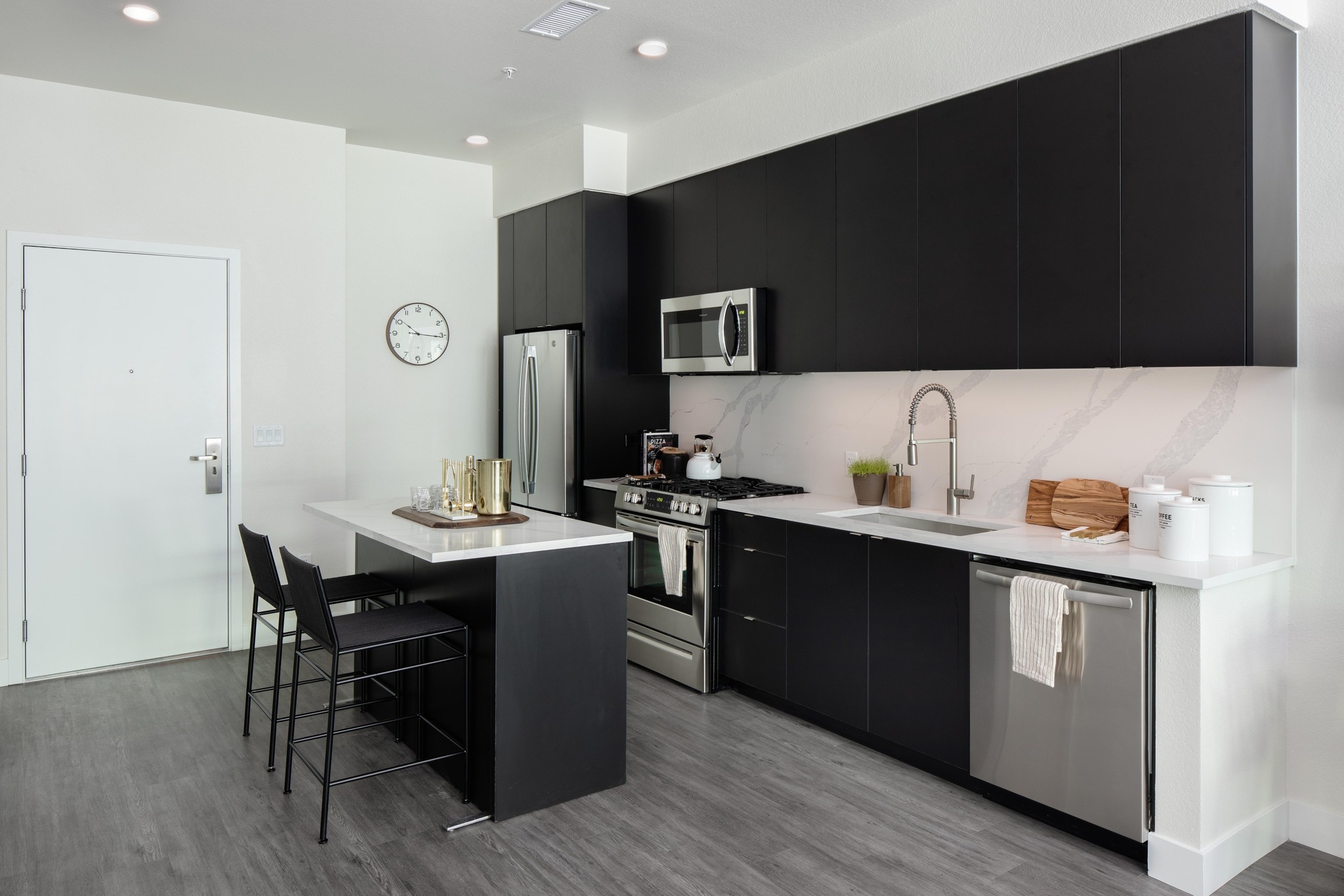 kitchen view with island and quartz backsplash modera art park apartment homes for rent in denver colorado