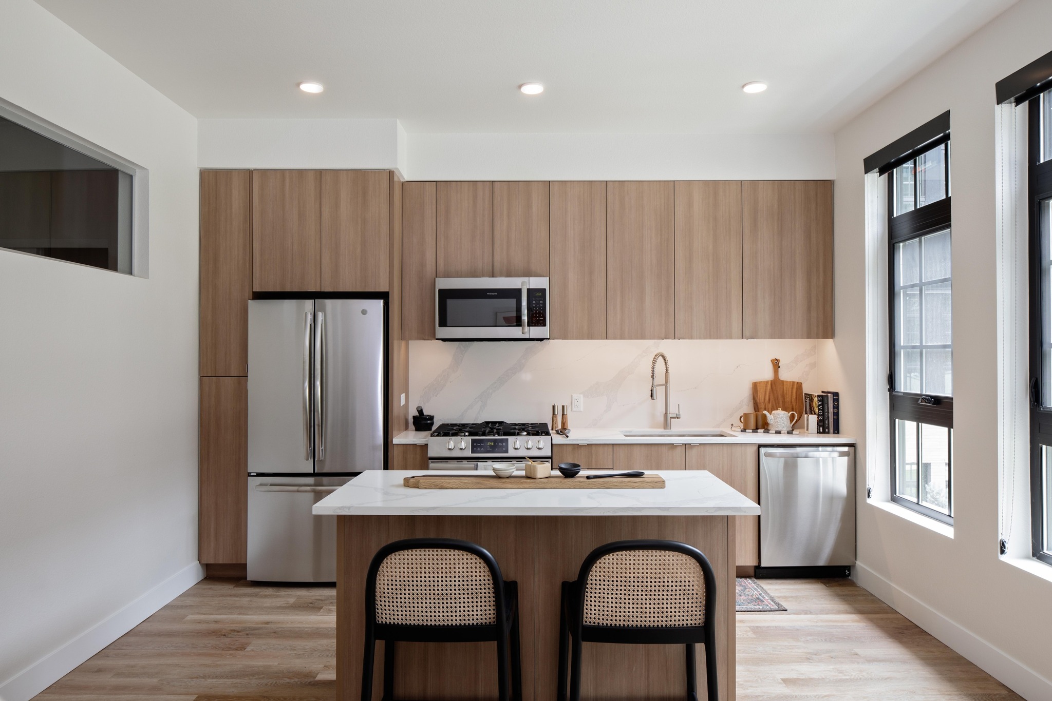 light wood cabinet in kitchen with island modera art park apartment homes for rent in denver colorado