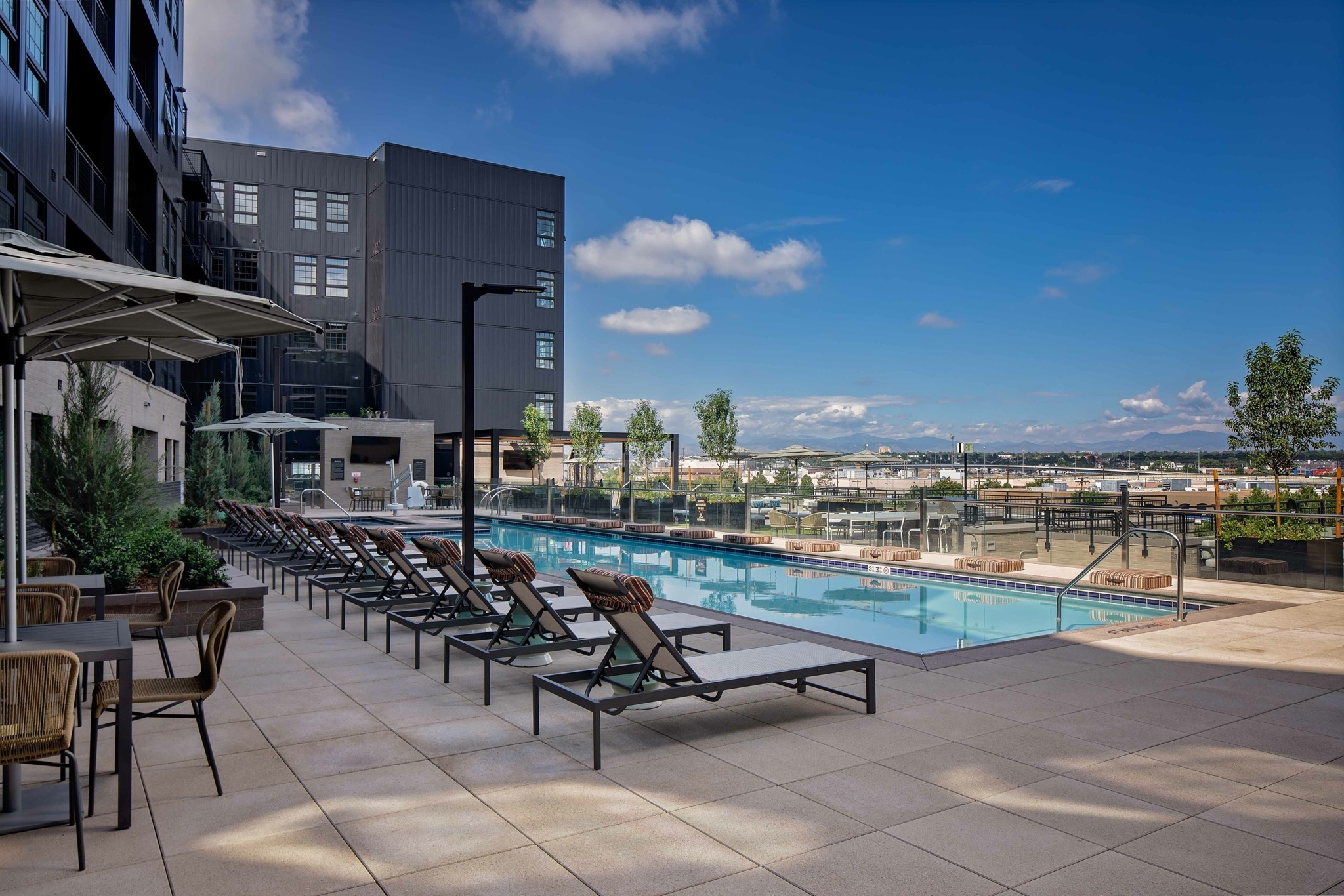 pool and sundeck with lounge chairs at modera art park apartment homes for rent in denver colorado
