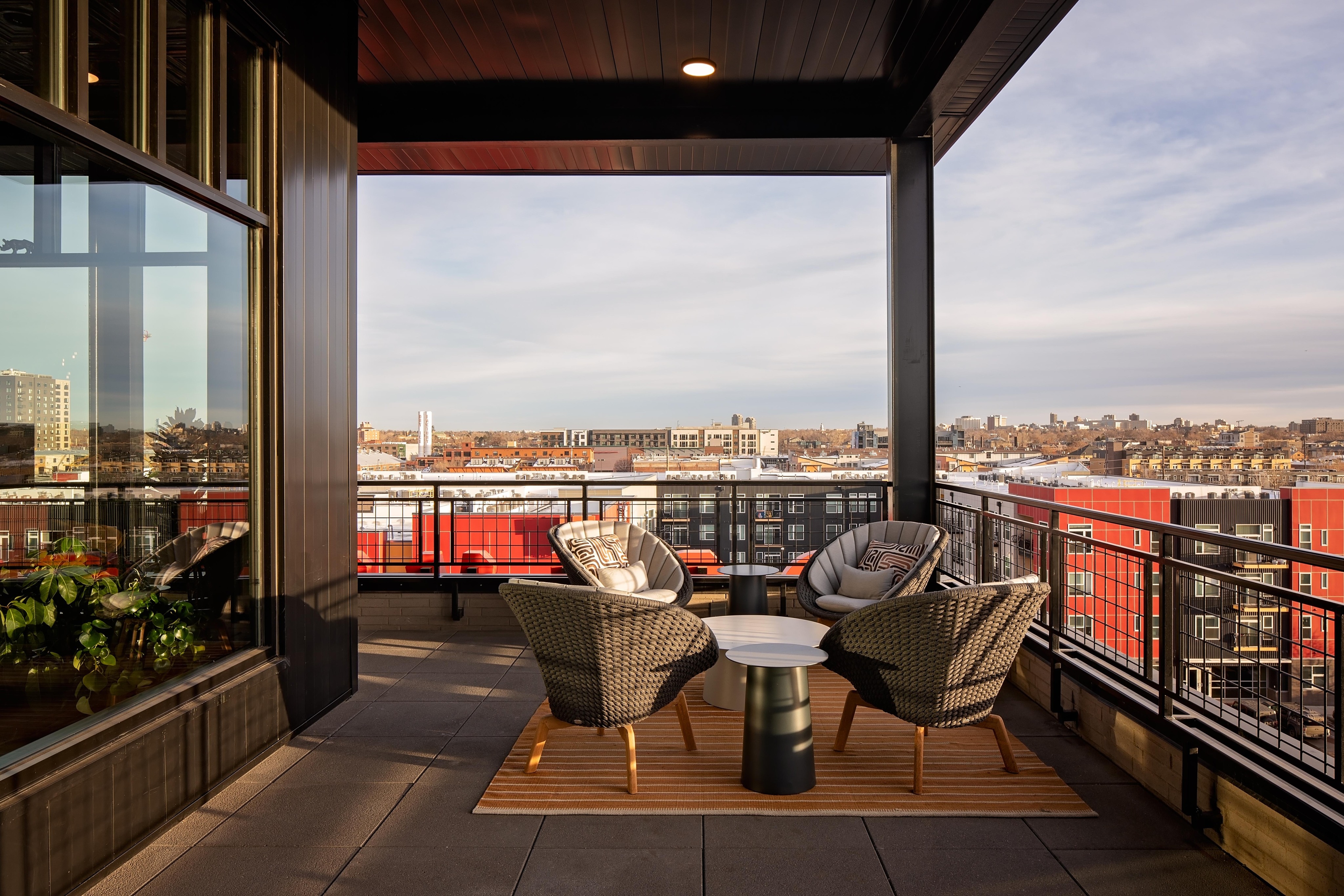 outdoor seating in rooftop lounge with city view modera art park apartment homes for rent in denver colorado