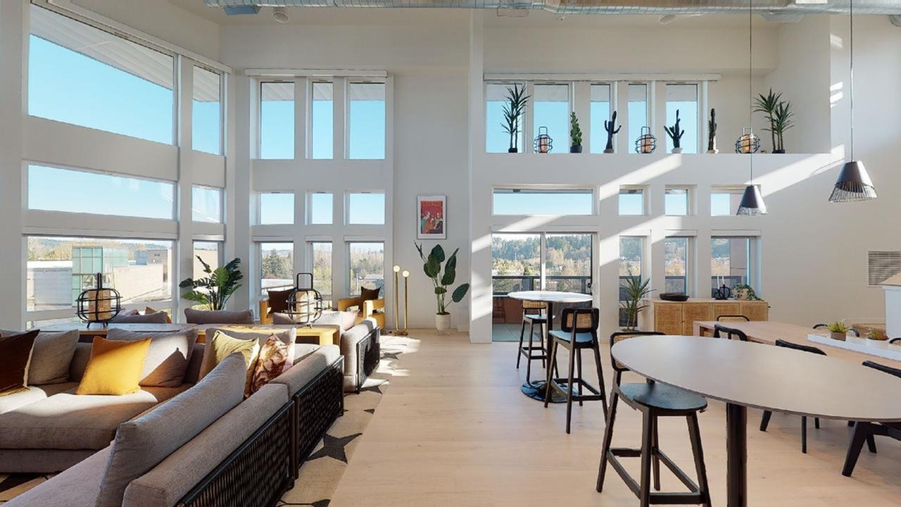 Lounge area with large HDTV and billiards table in background with another TV
