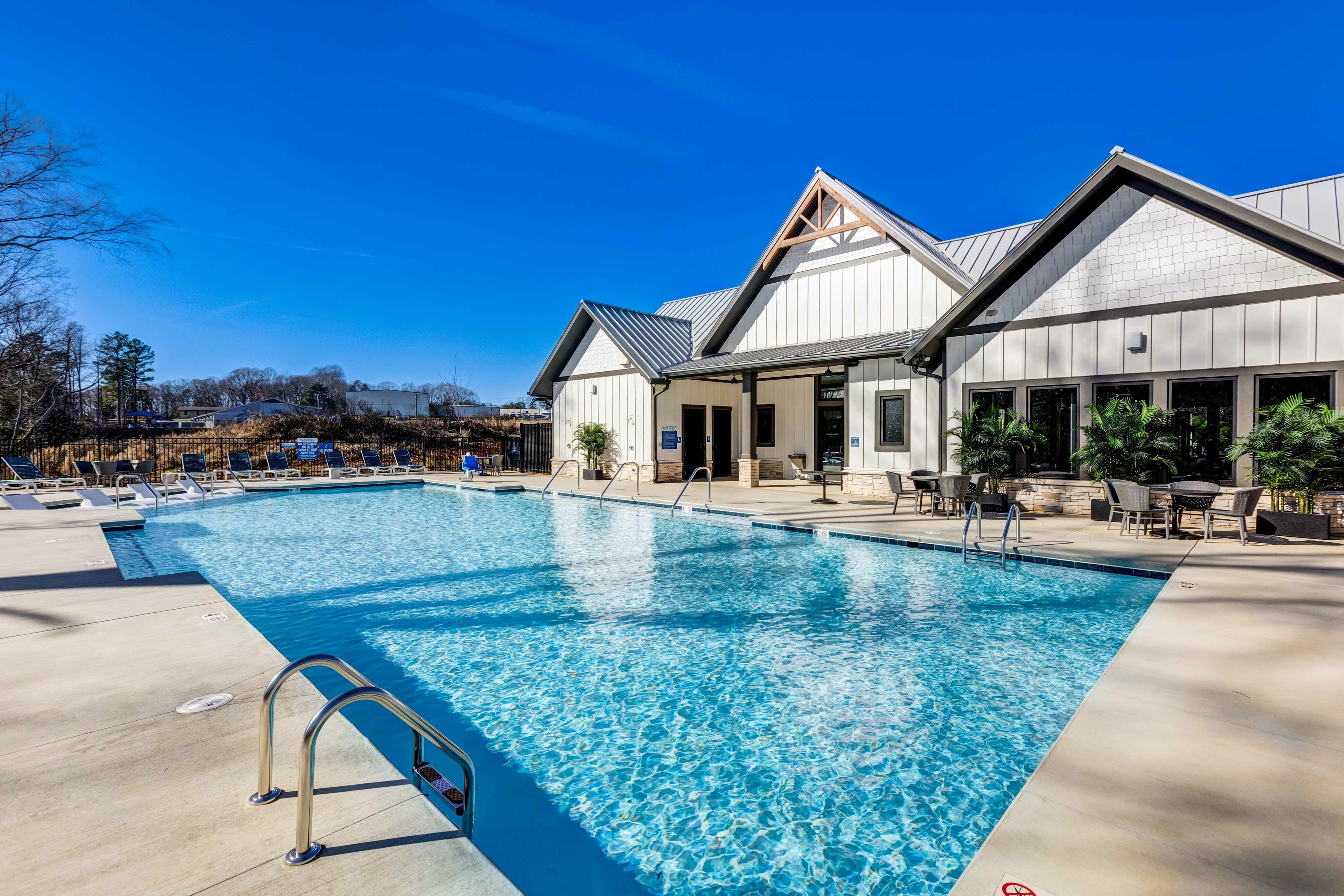 resort-inspired pool with lounge chairs at amavi sherrills ford single family homes for rent in north carolina
