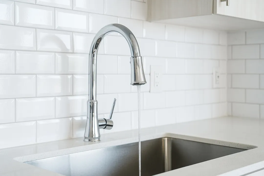 designer faucets and custom tile backsplash