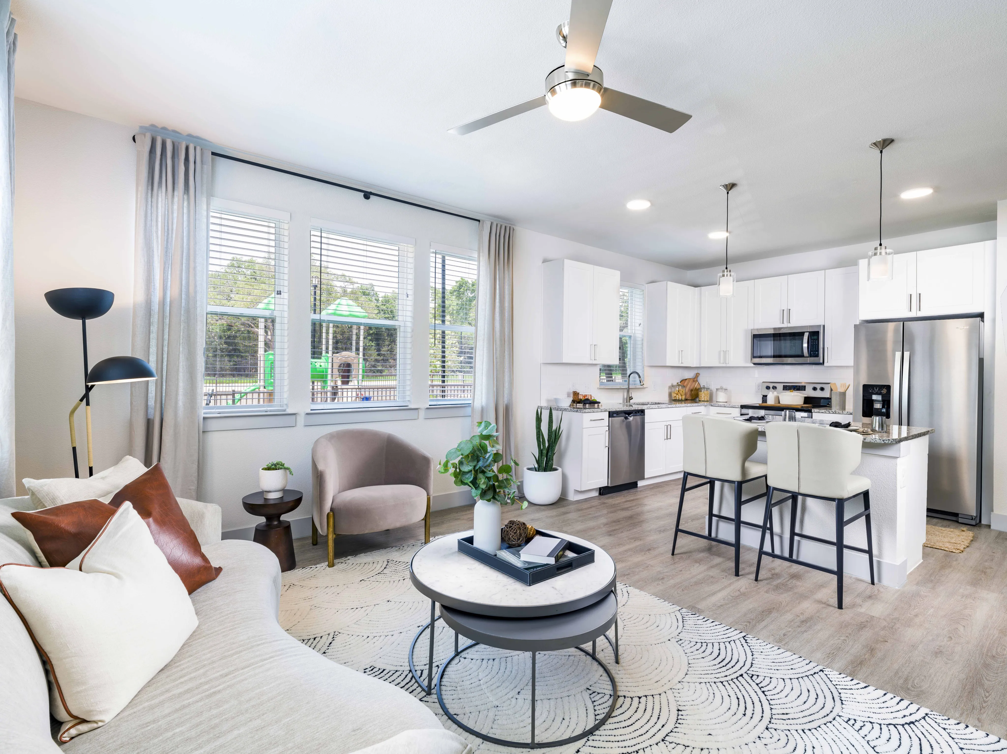 gourmet kitchen with granite countertops, white cabinetry, and more