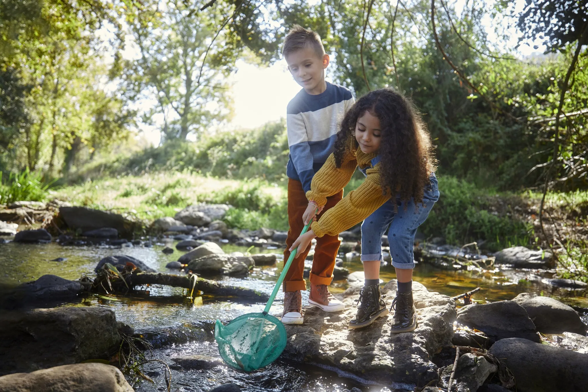 kids playing in creek with fishing net modera mckinney ridge apartment homes for rent in tx
