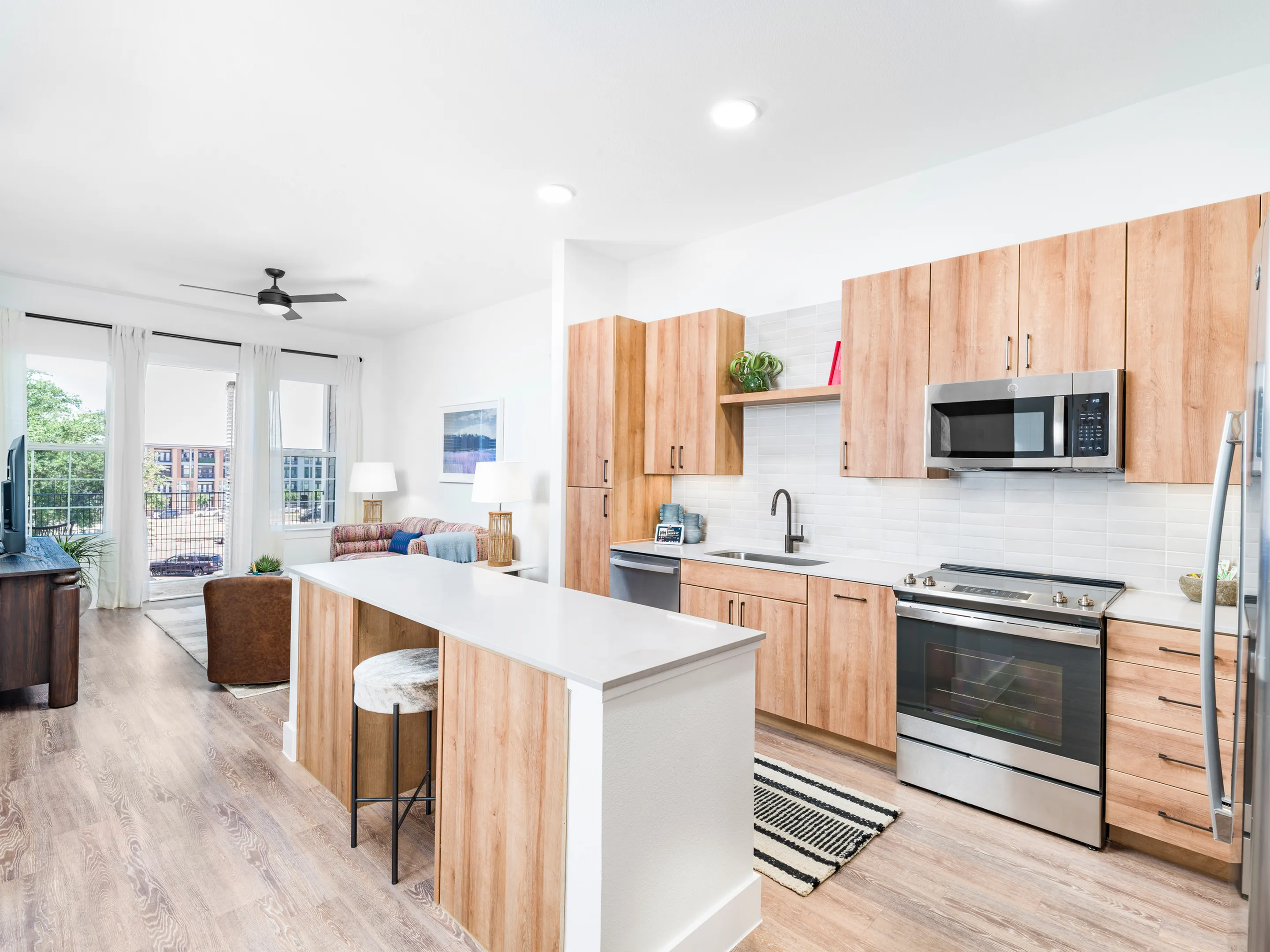 Stainless steel appliances and wood-style flooring in kitchen