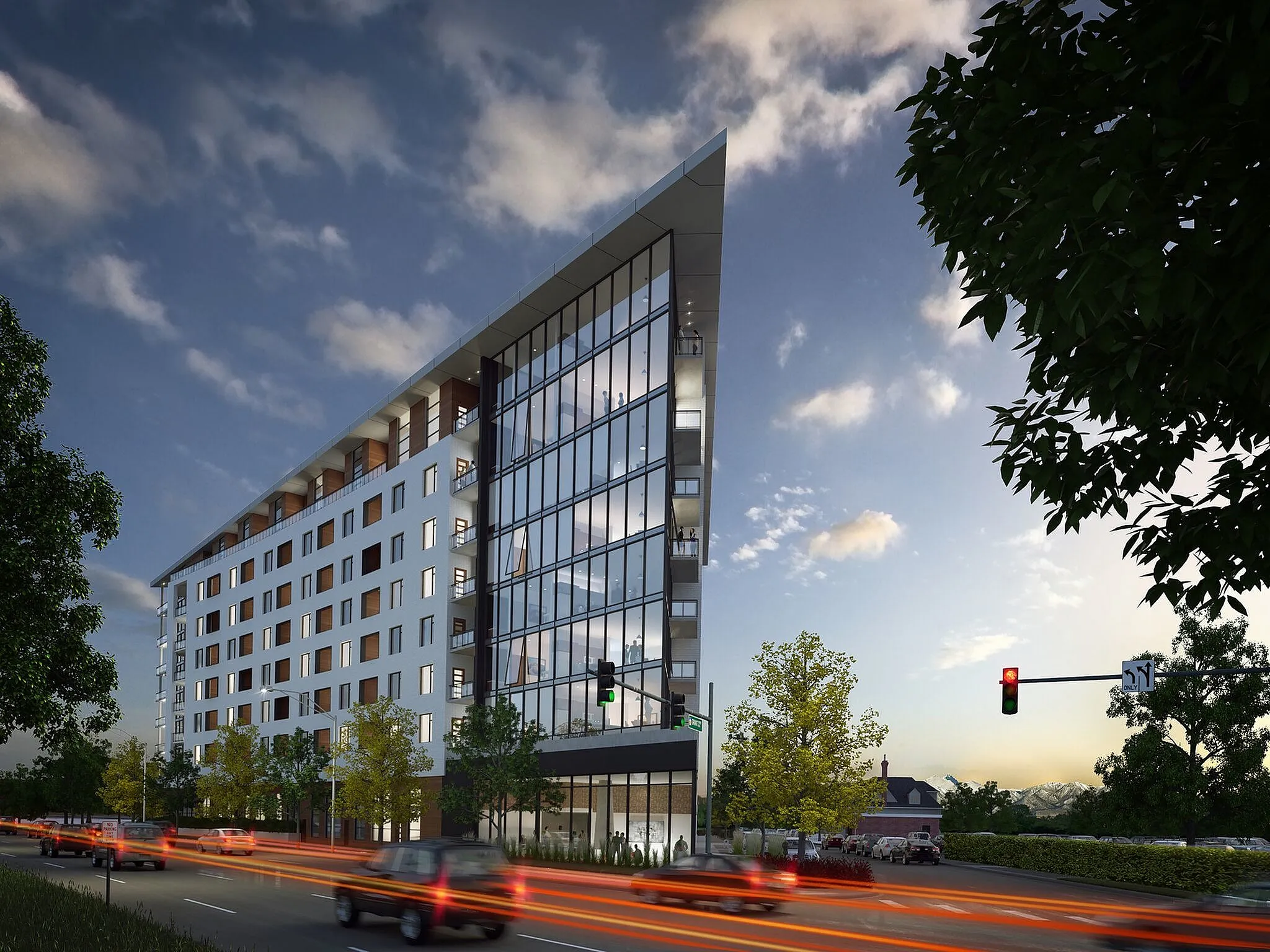 Modera West Wash Park building with sleek glass frontage and unique architecture, lined with lush greenery along a bustling city street at dusk.