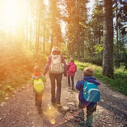 Family walking home from school on path Alister Lake Lynn