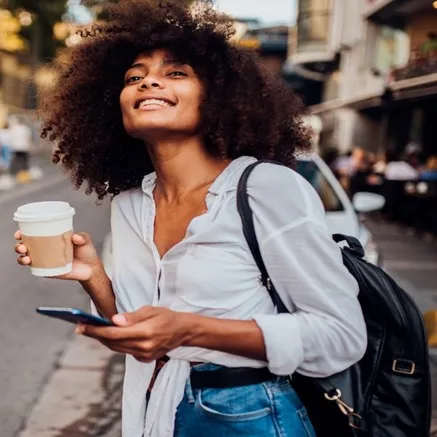woman carrying coffee cup alister galleria apartments