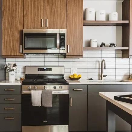 kitchen with two tone cabinetry and stainless steel appliances at modera reynoldstown apartments