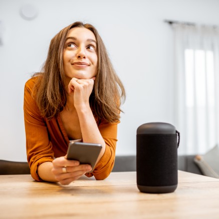 smart home tech depiction with smiling woman and phone