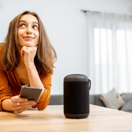 smart home tech depiction with smiling woman and phone