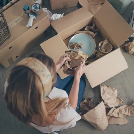 Image of woman packing apartment in boxes image
