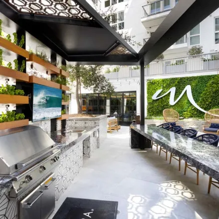 Kitchen in Ash Brown with Stainless Steel Appliances - Modera San Diego Apartments