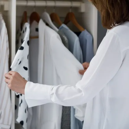 Woman shopping and looking at clothes hanging up