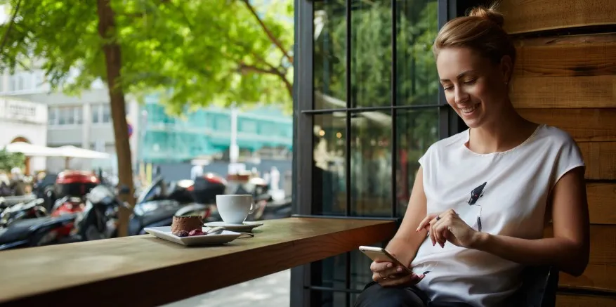 Woman at coffee shop using phone