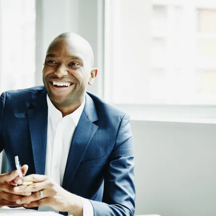 man in blue suit smiling