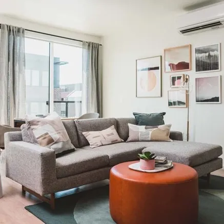 Modera Broadway apartment living room with sofa and coffee table