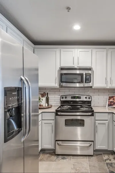 kitchen with stainless steel appliances at Alister Galleria apartment homes for rent