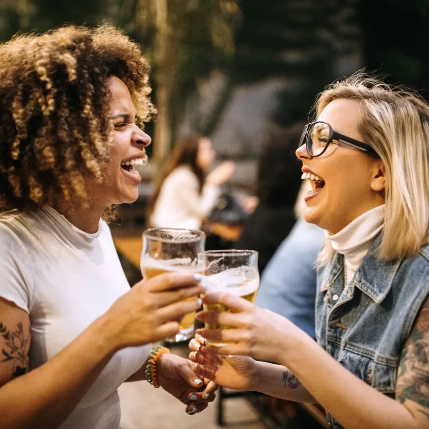 women having drinks and laughing together modera st petersburg apartment homes for rent in florida