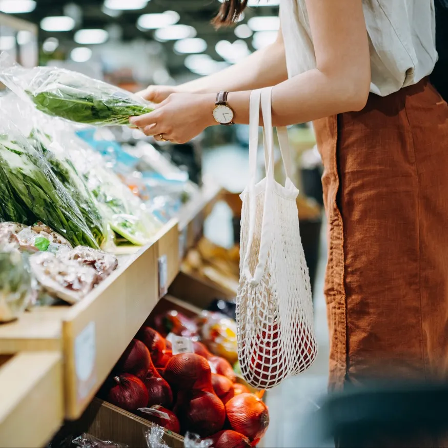person shopping in produce section modera argyle apartment homes for rent