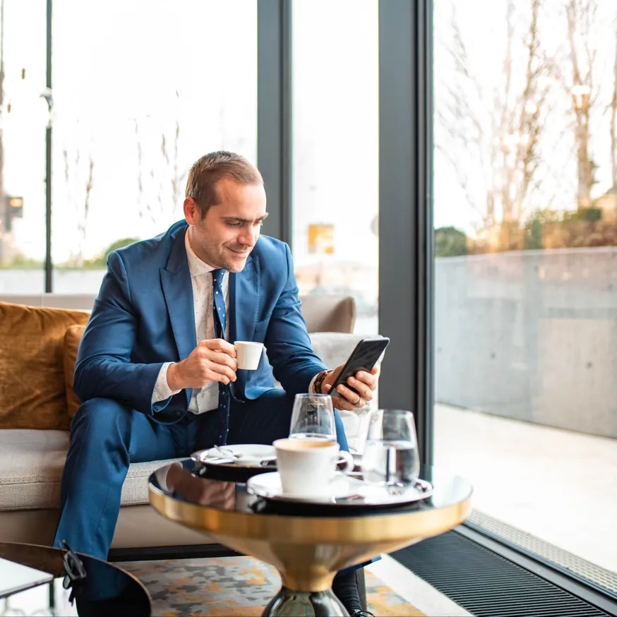 man smiling while looking at phone modera argyle apartment homes for rent in ca
