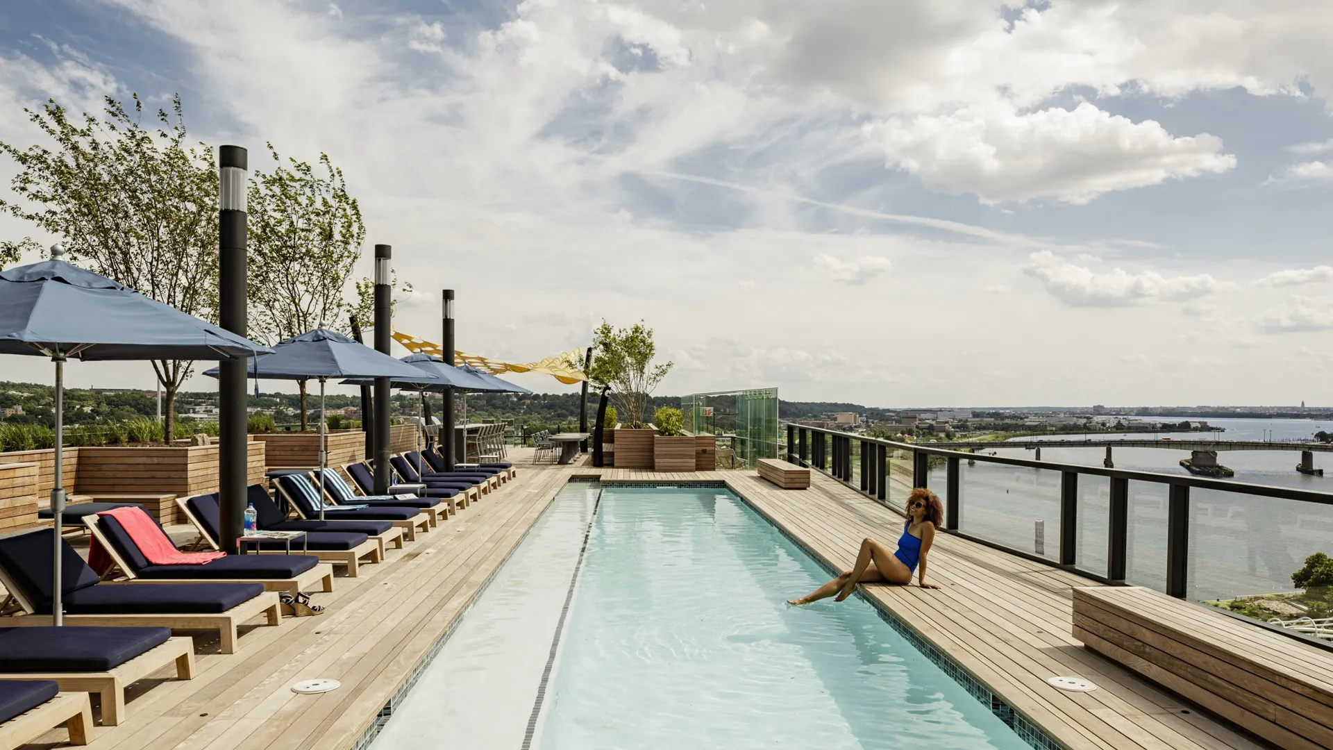 woman resting legs in arris rooftop pool apartment homes for rent in washington dc