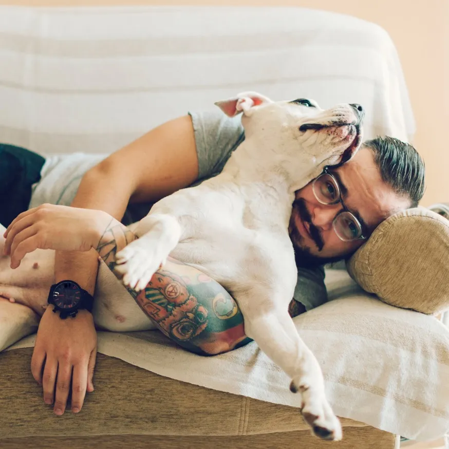 man cuddling with dog modera douglas station apartment homes for rent fl