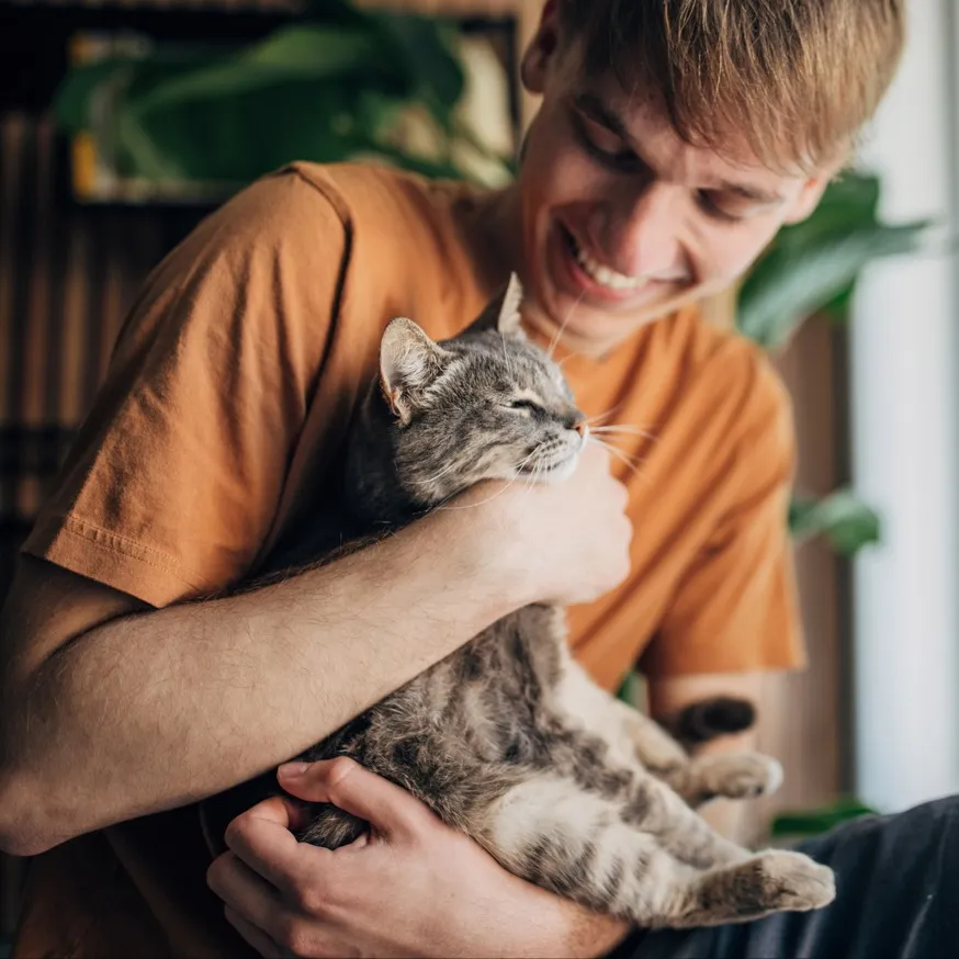 man holding cat and smiling modera academical village apartment homes for rent in davie fl