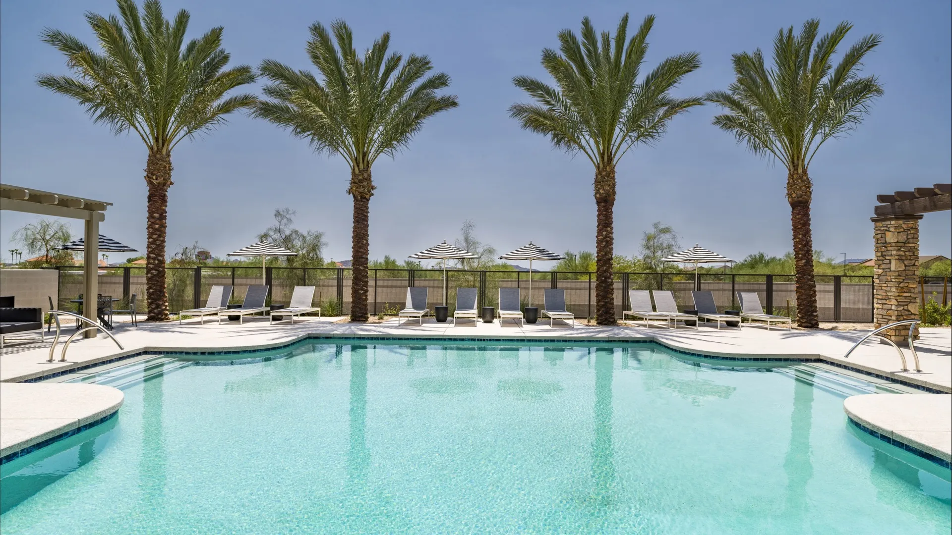 pool on sunny day with deck homes for rent at Amavi Aster Ridge community in Phoenix Arizona