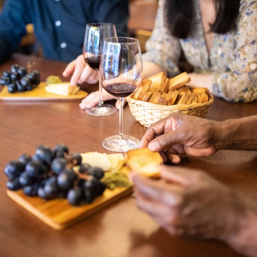 People eating charcuterie food on charcuterie boards