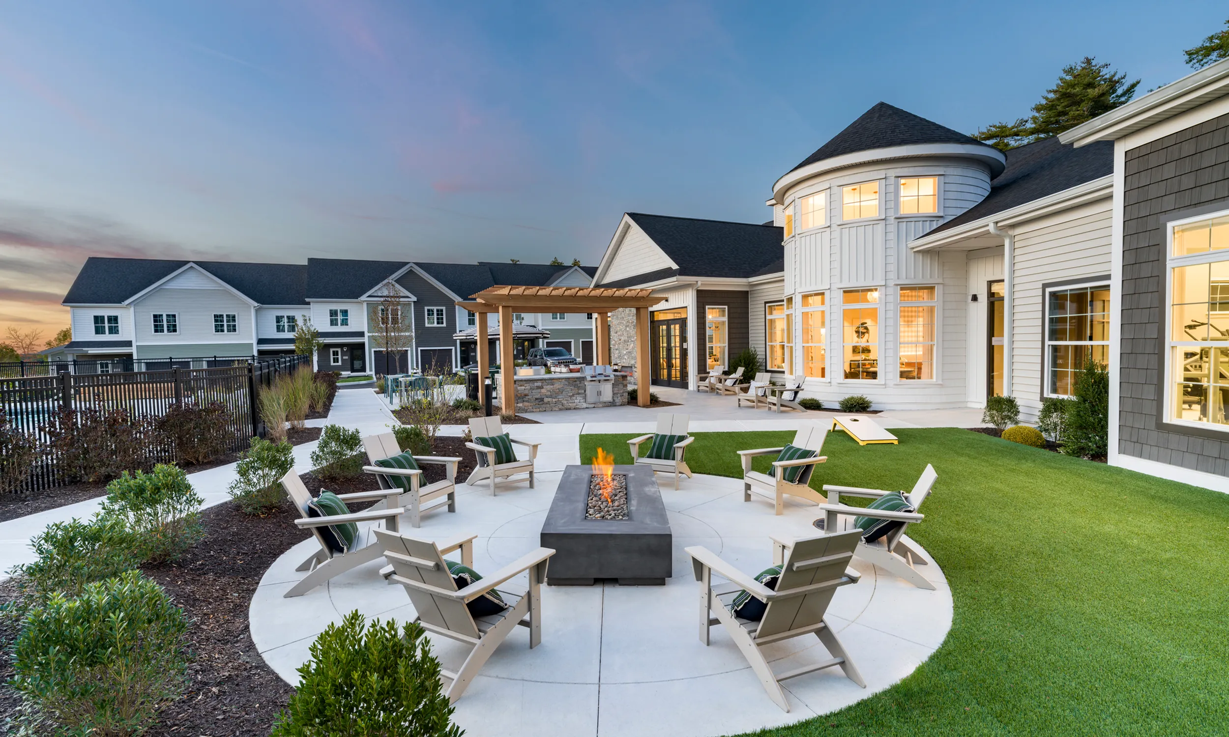 Charming outdoor space with cozy fire pit, elegant patio furniture, and modern architecture modera south shore apartment homes for rent marshfield ma