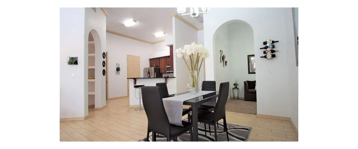 Furnished dining area shown — representative home at 9920 Apartments.
