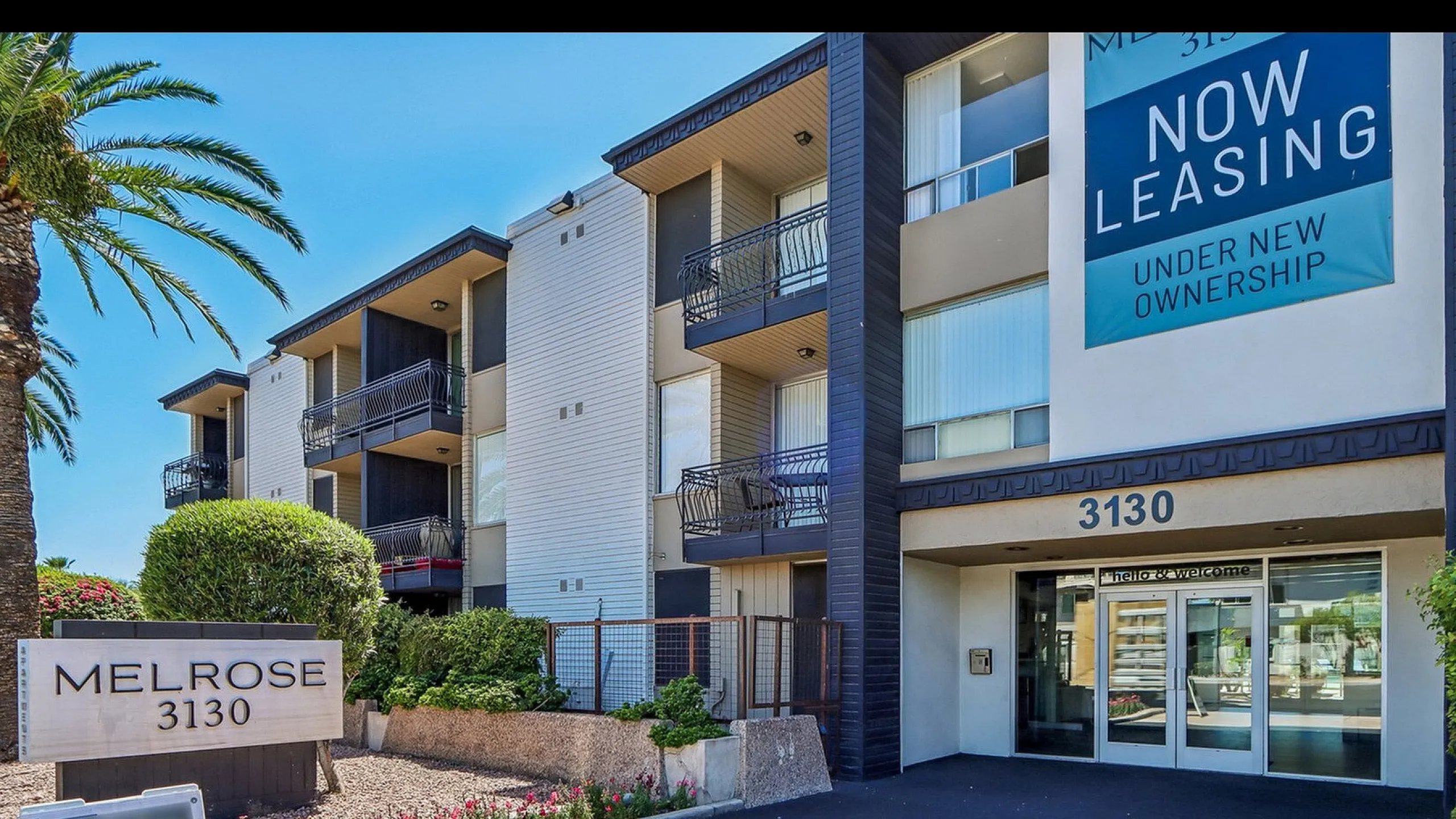 Modern apartment complex Melrose 3130 with stylish architecture, lush landscaping, and a welcoming entrance under new leasing.