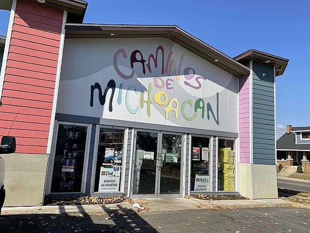 Charming storefront with colorful signage of 'Camino de Michoacan,' featuring vibrant architecture and inviting entrance.