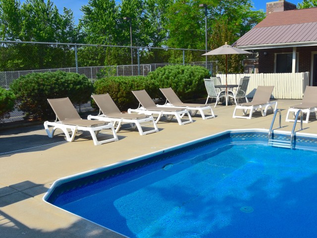 Pool with multiple pool chairs surrounding